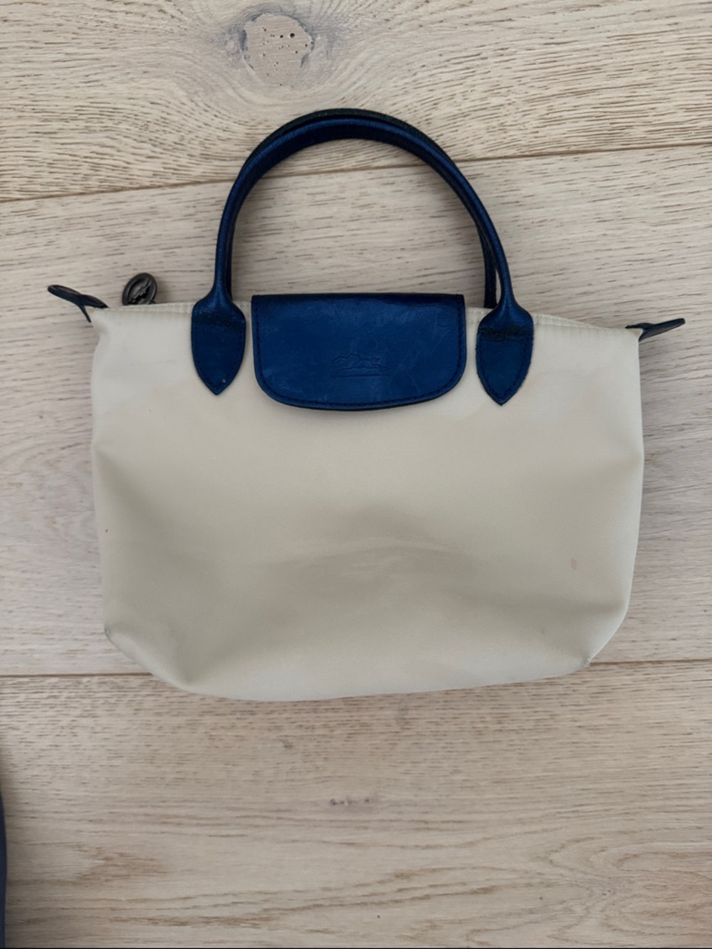 Longchamp Le Pliage Cream Tote with Navy Trim. Top zip with snap flap.